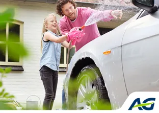 Un père et sa fille lavent une voiture